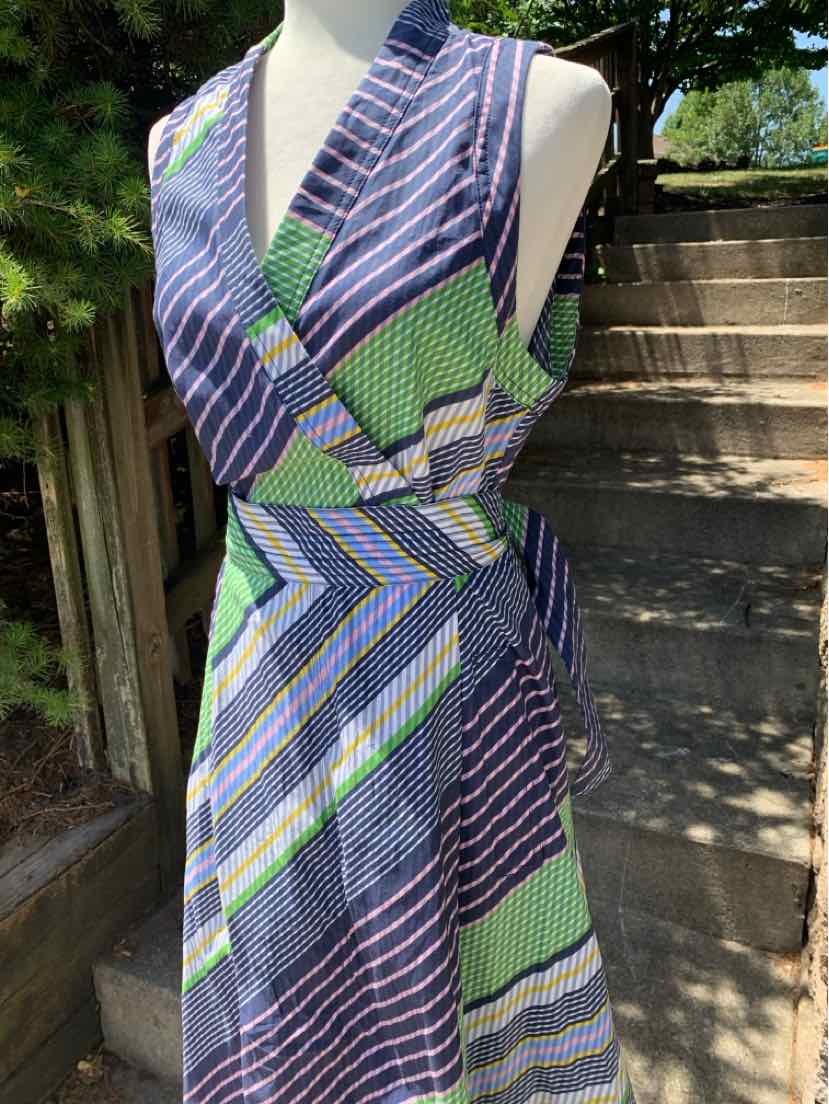 Sleeveless wrap dress with blue, green, and white diagonal stripes, V-neck, and side tie at waist.