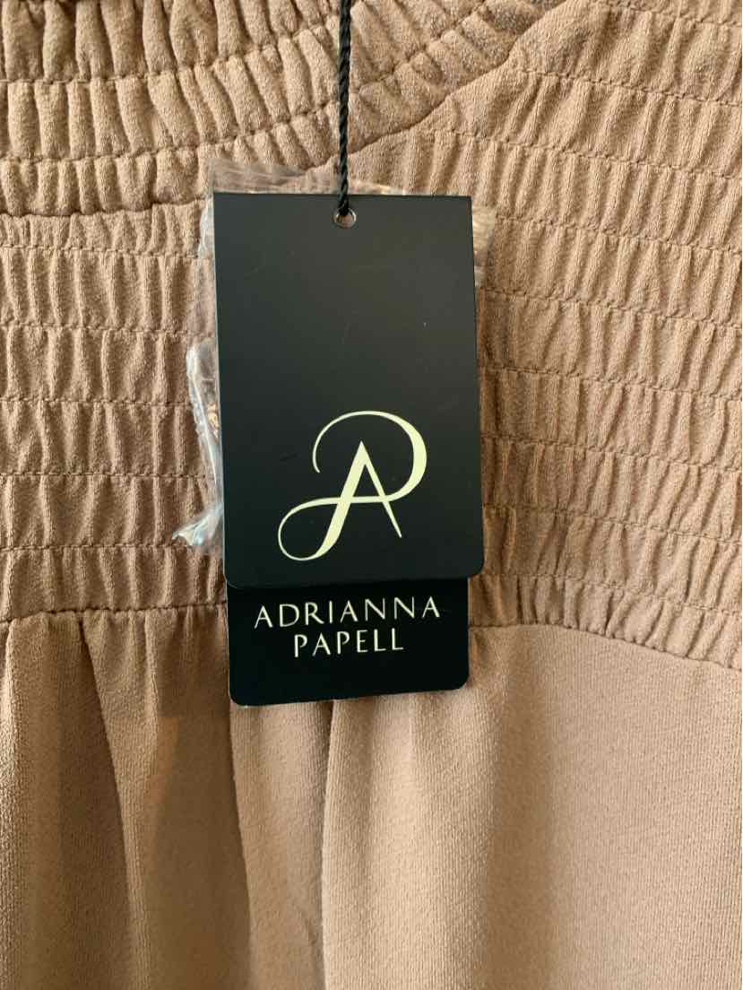 Beige fabric with ruched texture and Adrianna Papell black and gold brand tag attached.