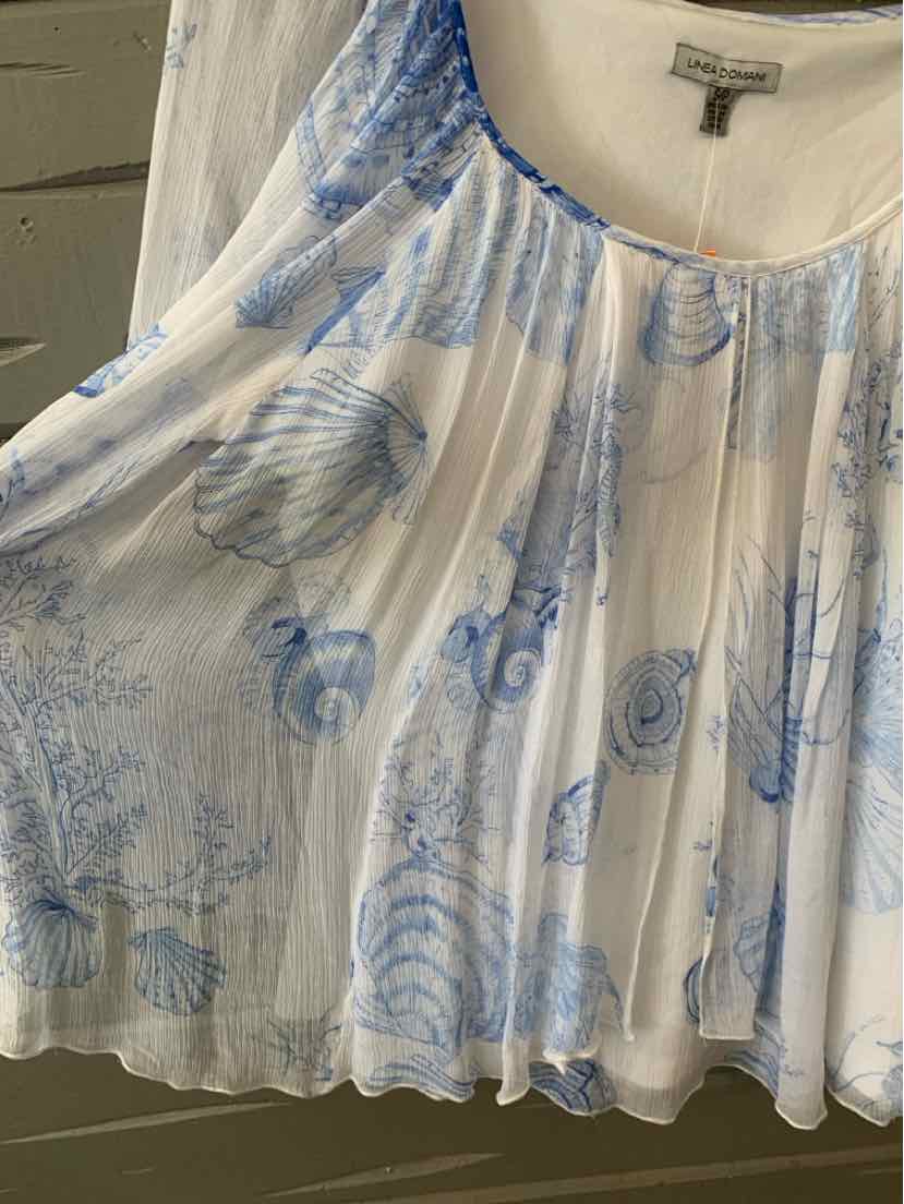 White sleeveless blouse with blue seashell and coral patterns, loose flowy fit, gathered neckline.