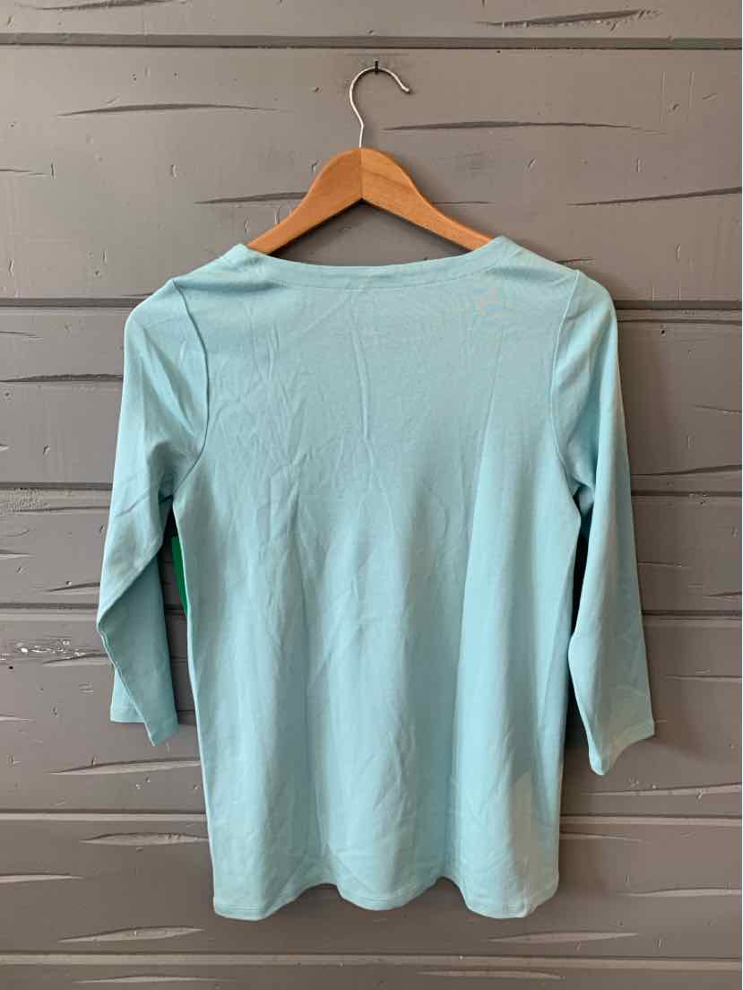 Light blue long-sleeve shirt with a scoop neckline and a fitted silhouette hanging on wooden hanger.
