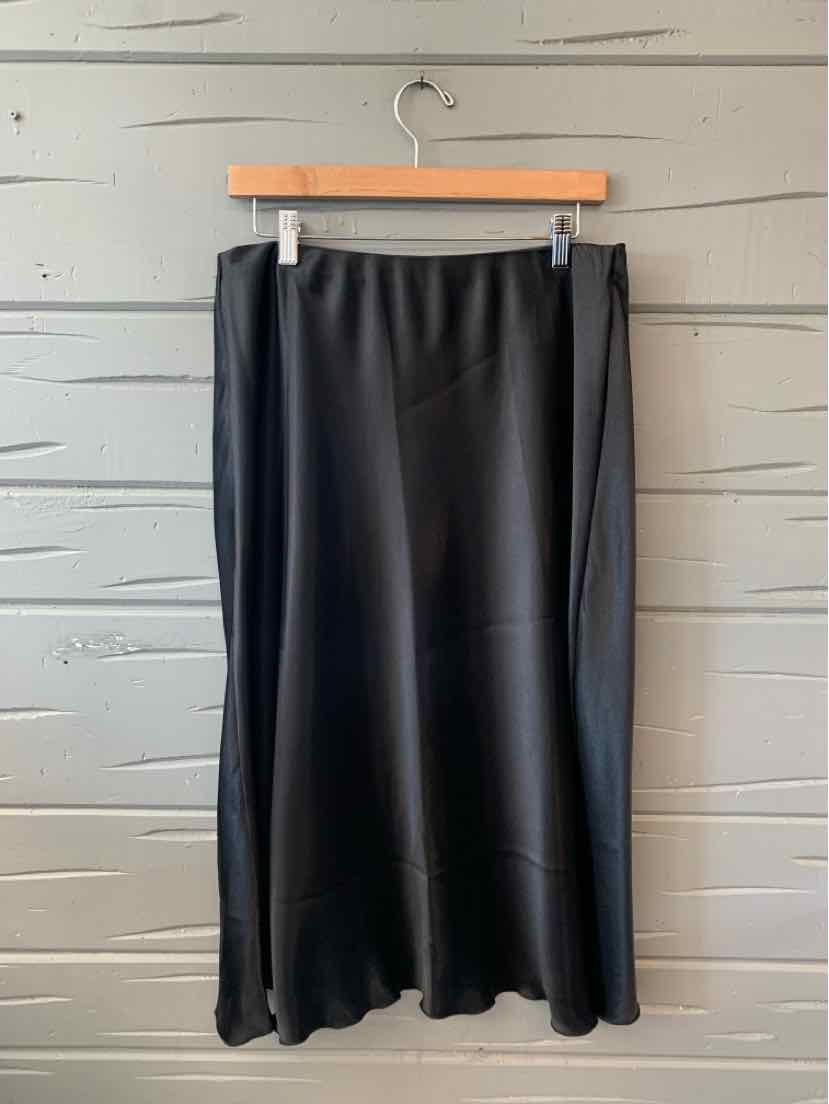 Black knee-length skirt with a slight flare and smooth fabric in size XL.