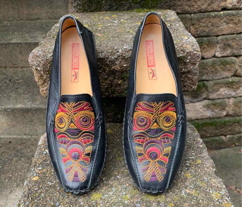 Black leather slip-on shoes with colorful embroidered geometric patterns on top, size 39.