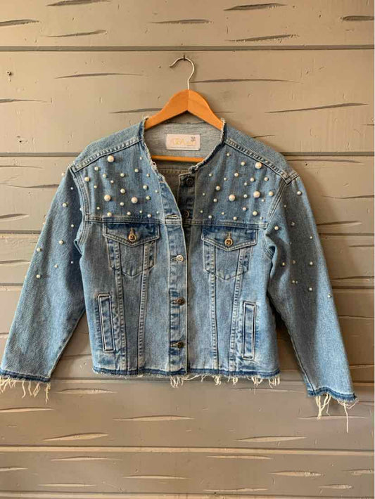 Light blue denim jacket with silver studs and pearl embellishments, frayed hem, and front pockets.