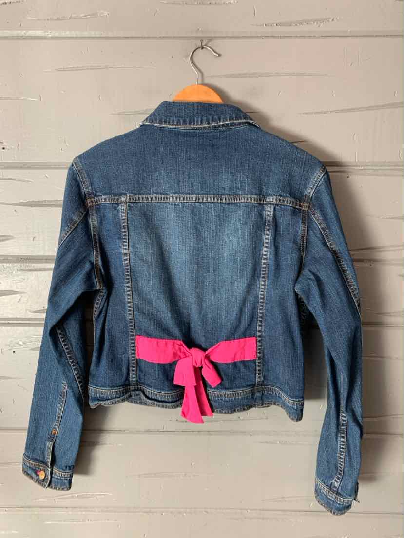 Medium-wash denim jacket with a bright pink bow tied across the back waist.