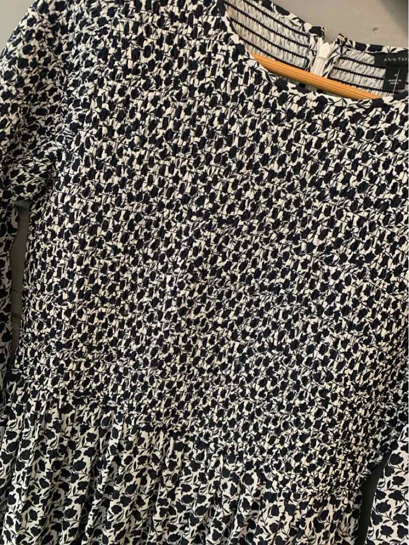 Black and white floral print Ann Taylor dress with gathered waist, size 4, hanging on wooden hanger.