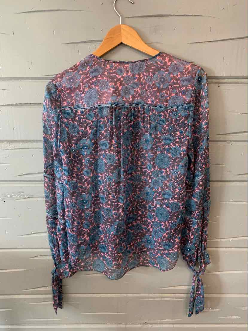 Sheer long-sleeve blouse with blue and pink floral print, tie cuffs, and a loose fit.