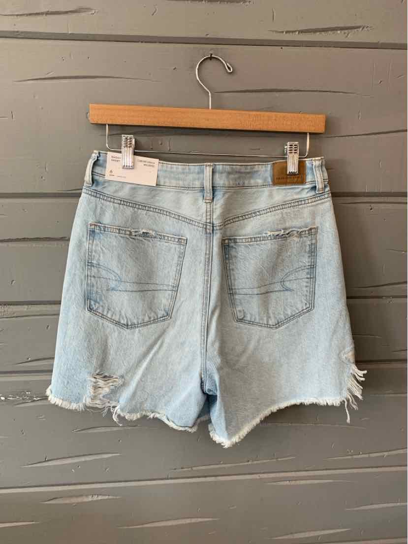 Light blue distressed denim shorts with frayed hems and back pockets, size 6.