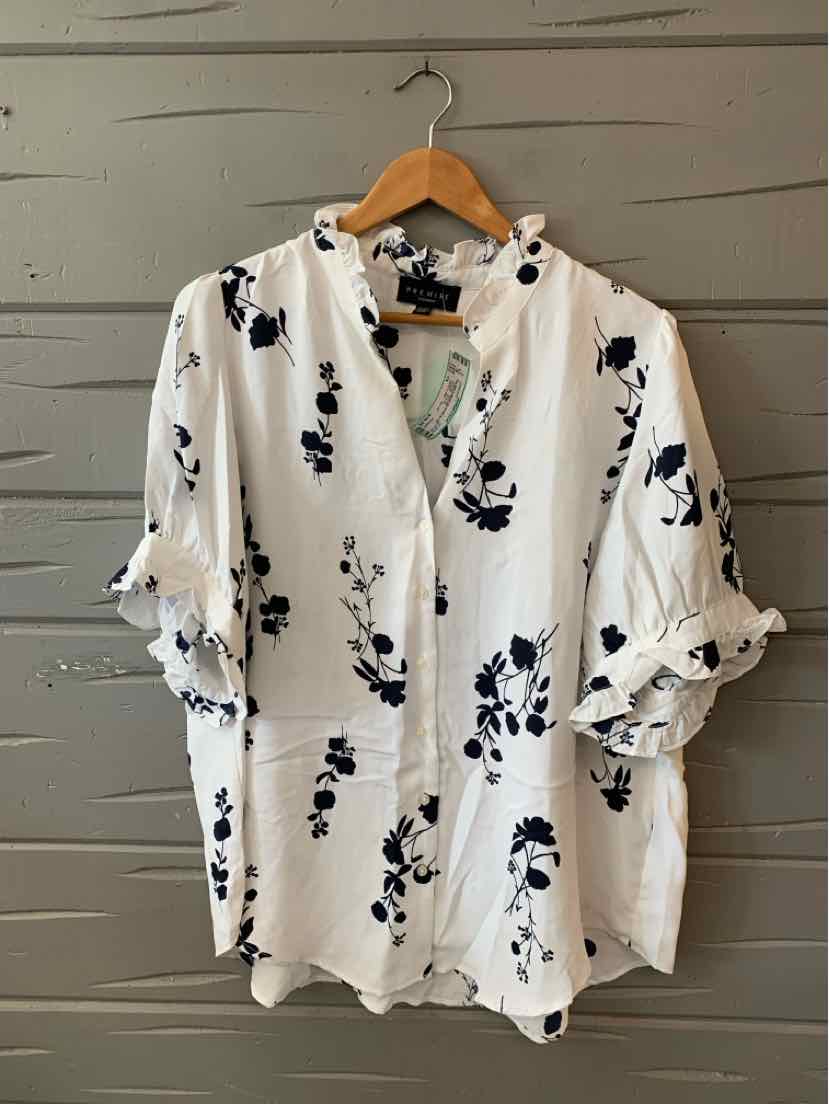 White blouse with black floral print, ruffled sleeves, and front button detail in size 1X.
