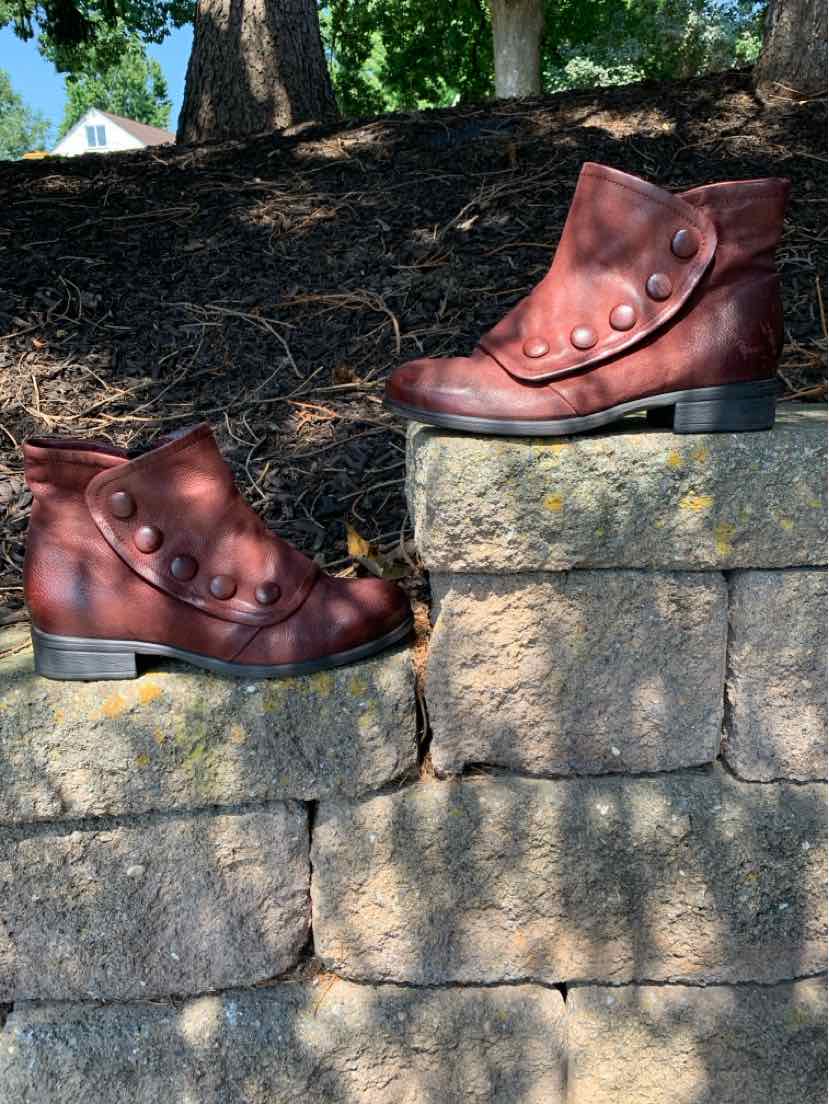 Women's burgundy leather ankle boots with round buttons and low block heels.