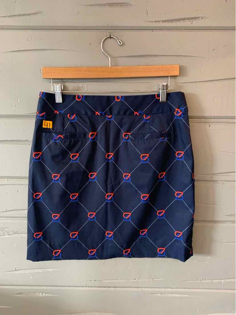 Navy blue skirt with diagonal red diamond pattern and small logos, straight cut, size 4.