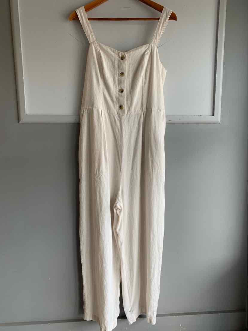Tan sleeveless jumpsuit with wide legs and brown buttons down the front.