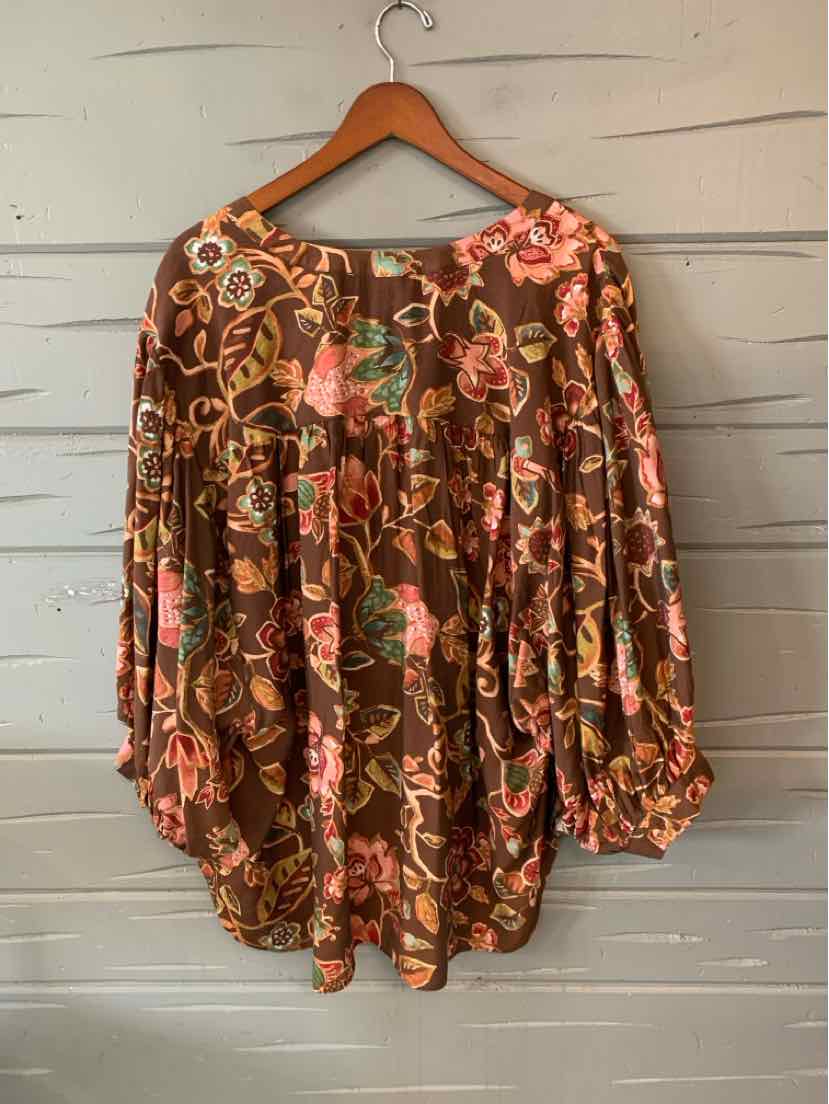 Brown floral blouse with pink and olive rose patterns, loose fit, long puffed sleeves, round neckline.