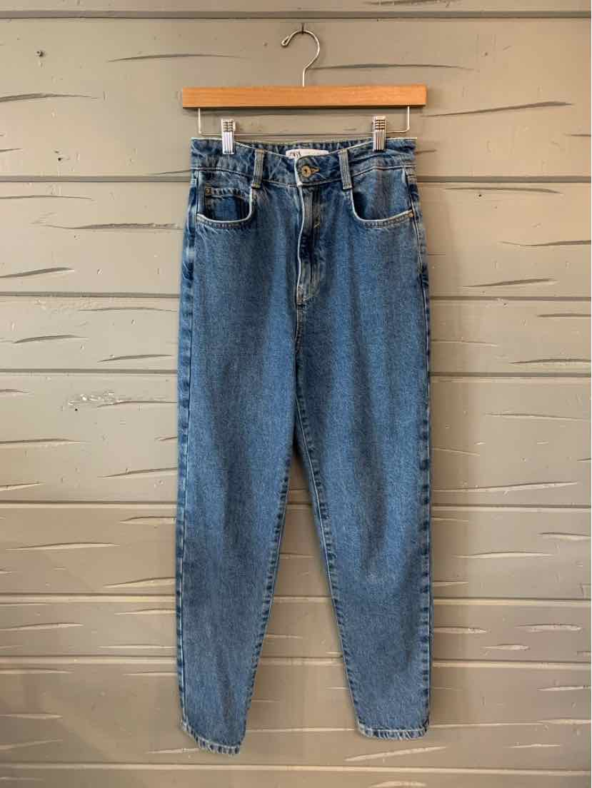 High-waisted blue denim jeans with tapered legs, five-pocket design, and button fly closure.
