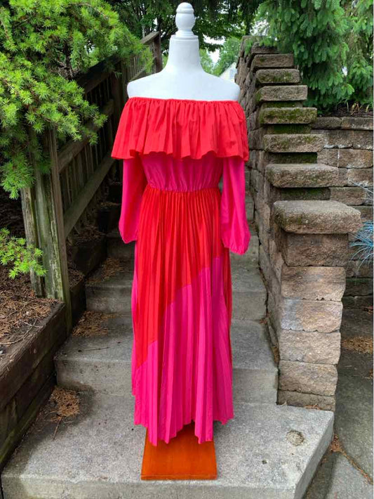 Pink and red off-shoulder midi dress with ruffle neckline and long sleeves.