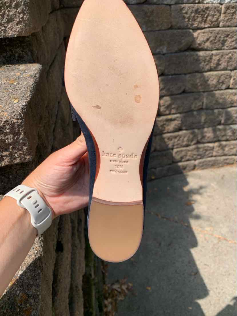 Black leather pointed-toe flat shoe with smooth beige sole and small heel, size 10.
