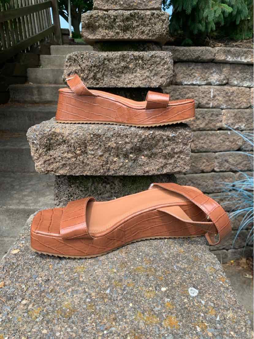 Tan platform sandals with woven texture, ankle strap, and open toe in size 9.