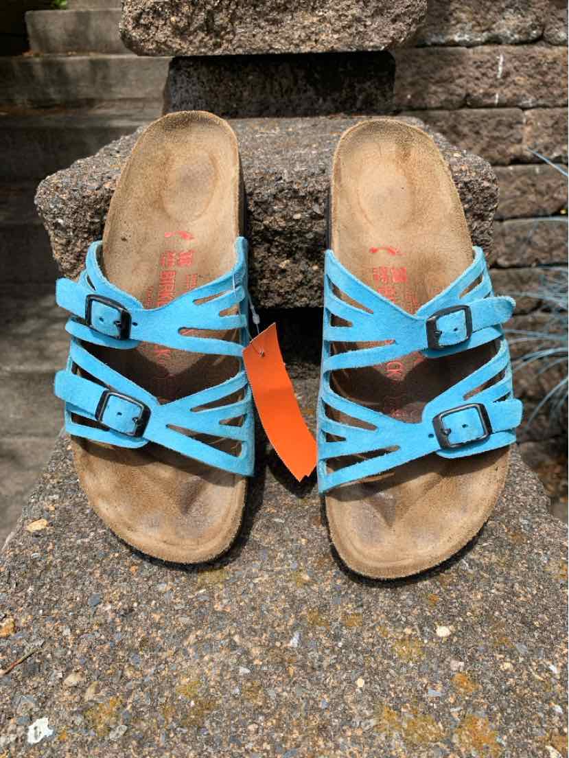Blue leather Birkenstock sandals with two adjustable straps and cork footbeds, size 38.