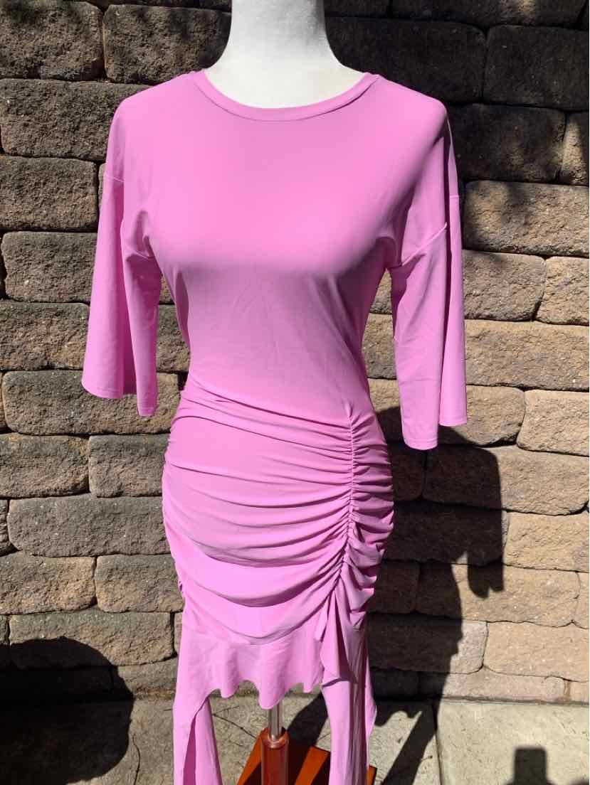 Pink fitted dress with three-quarter sleeves and ruched detailing on one side.