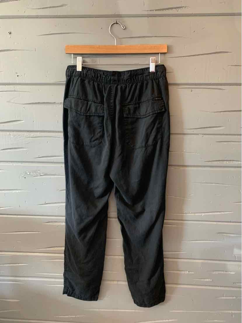 Black mid-rise pants with elastic waistband and rear patch pockets, medium size.