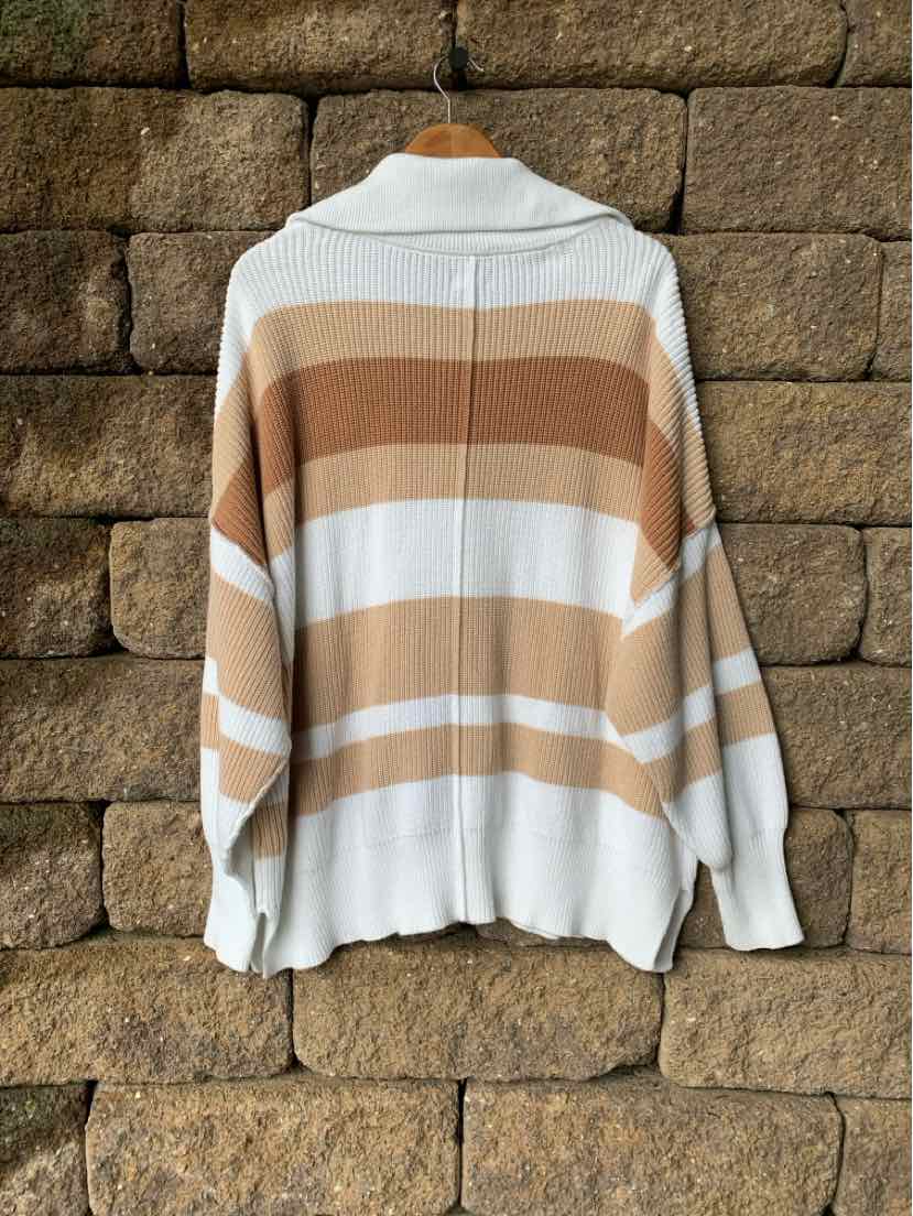 Oversized knit sweater with wide horizontal stripes in cream and tan, featuring a folded collar and long sleeves.