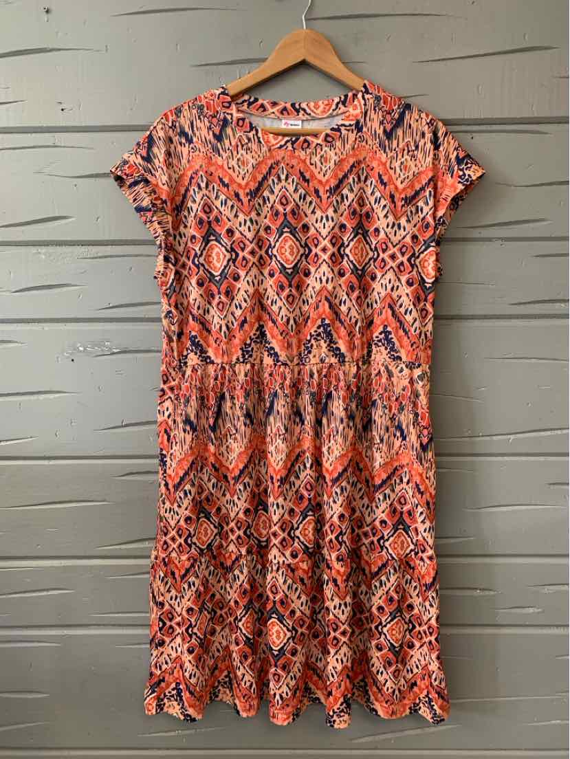 Orange and black geometric pattern short-sleeve knee-length dress in XL size on wooden hanger.