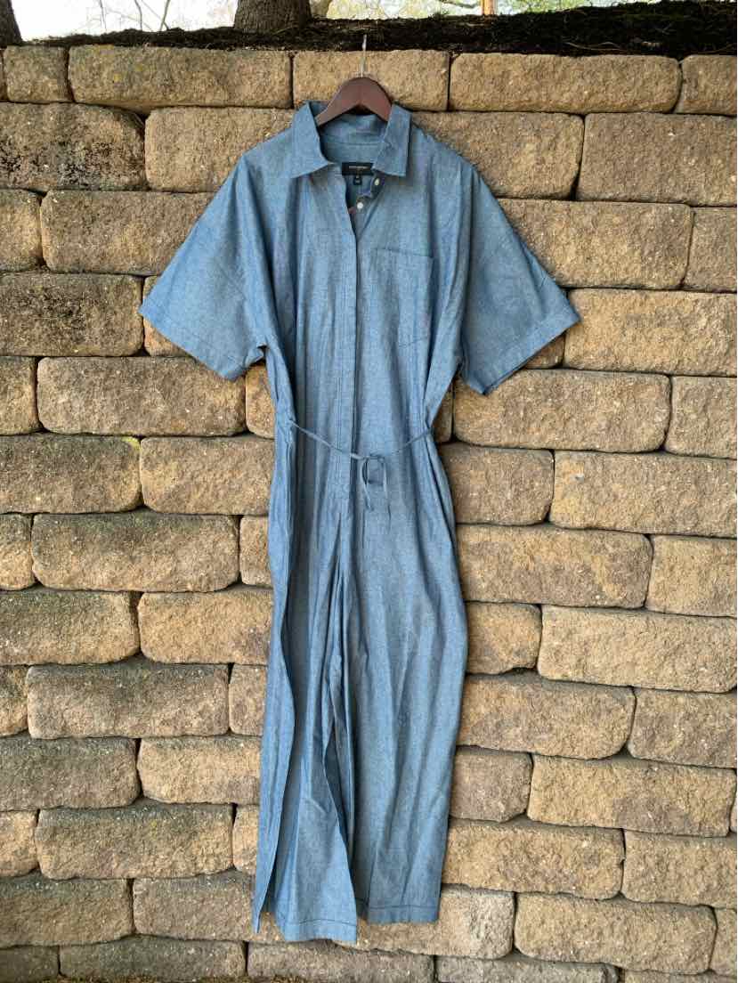 Blue short-sleeve button-up jumpsuit with collar and fabric belt at waist.