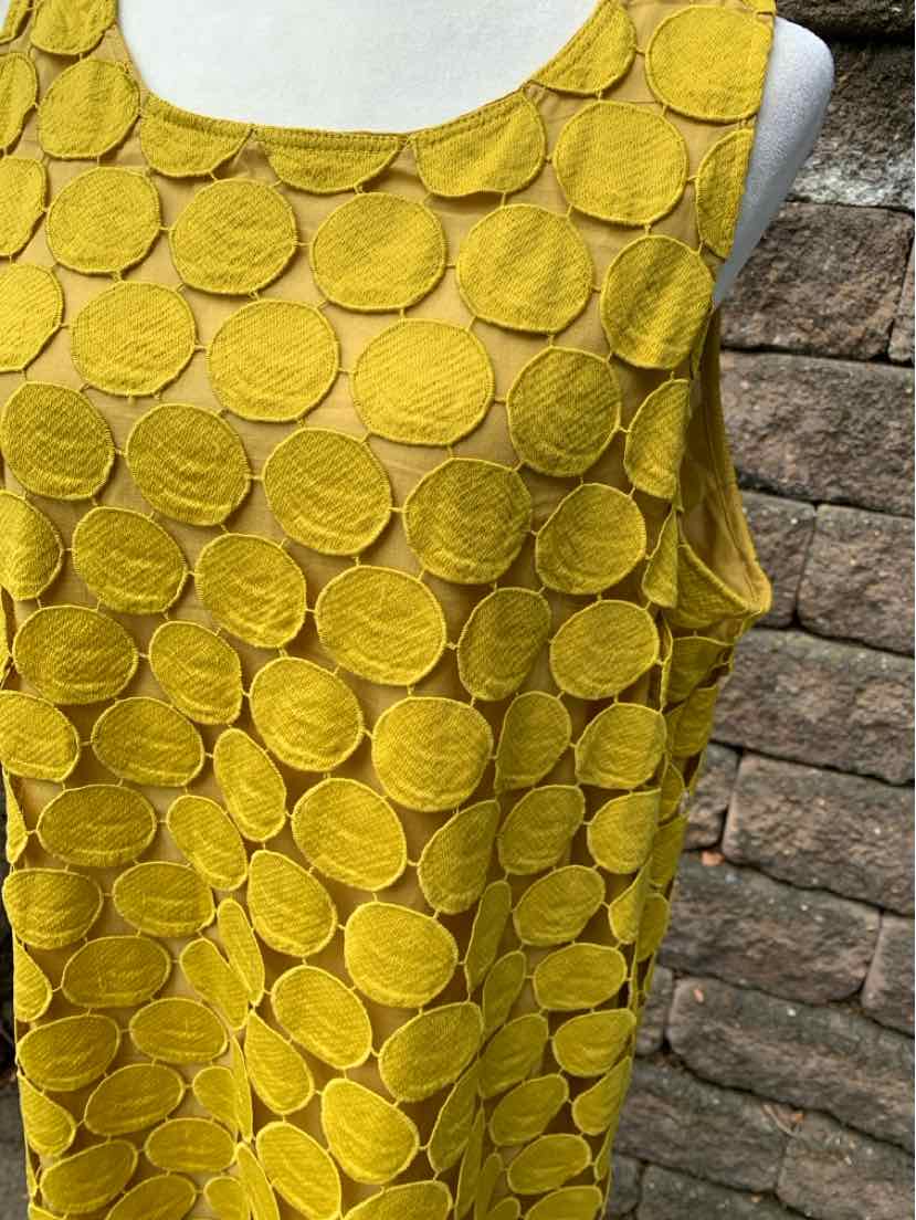 Sleeveless mustard yellow dress with layered circular fabric patterns and a scoop neckline.