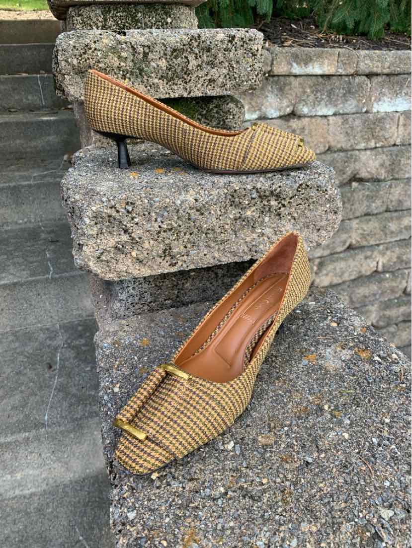 Tan houndstooth Franco Sarto pointed-toe pumps with slim heels, shown from the side and above.