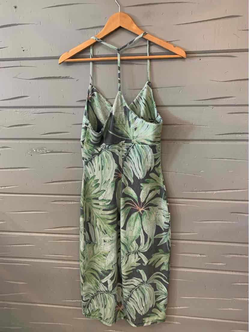 Green tropical print sleeveless jumpsuit with spaghetti straps and front knot detail.