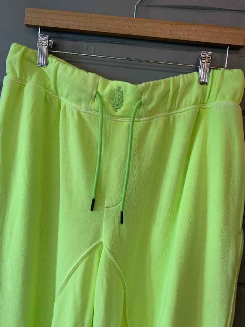 Neon green cotton blend lounge pants with elastic waistband and drawstring front.