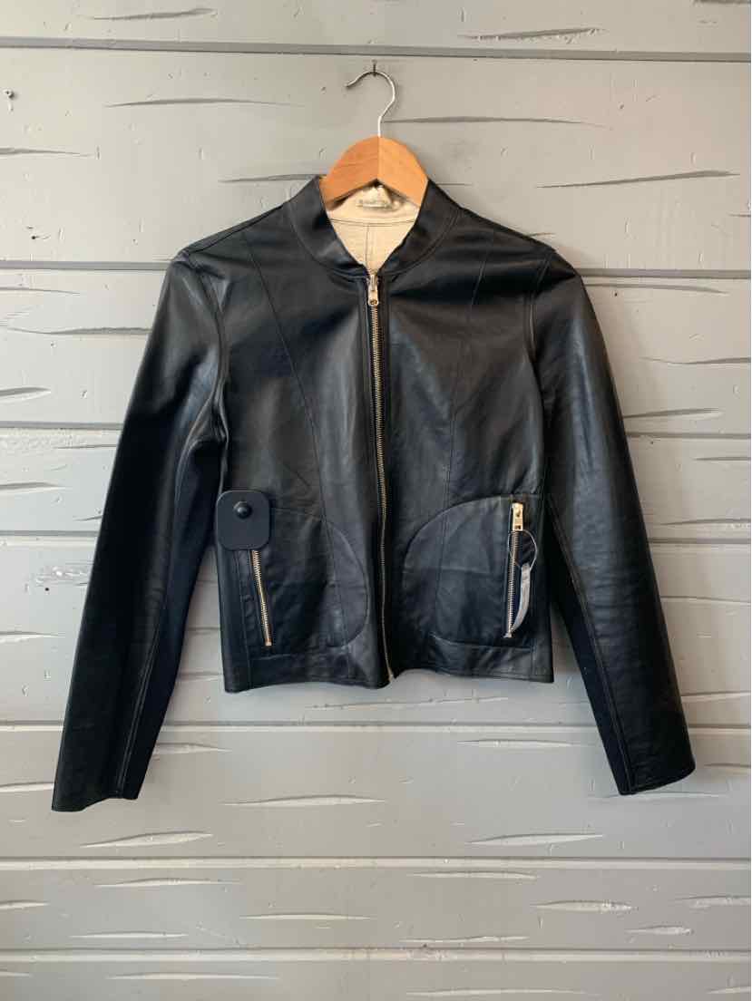 Black leather jacket with a notched collar, front zipper, zippered pockets, and long sleeves.
