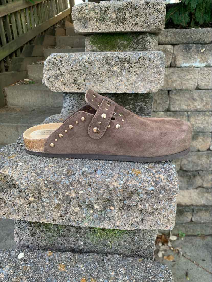 Brown suede studded slip-on clog with an adjustable strap and tan wooden sole.