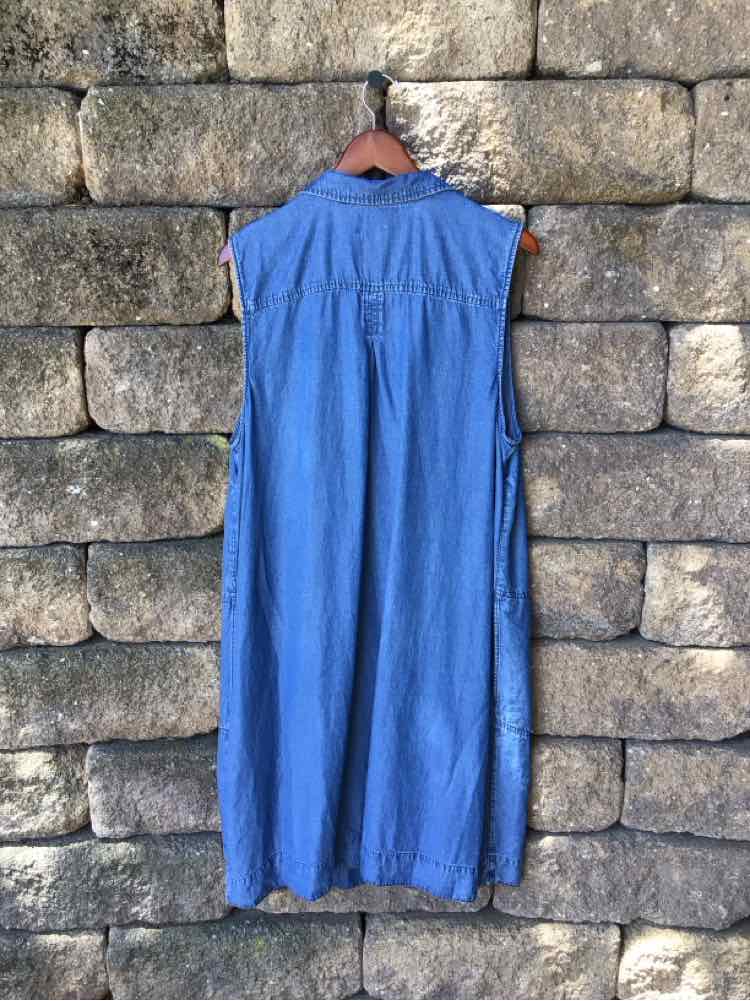 Sleeveless long denim dress in medium blue with a gathered back yoke detail and relaxed fit.