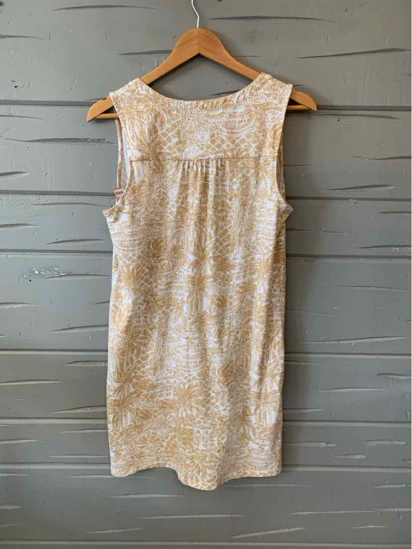 Sleeveless tan shift dress with white abstract print, scoop neckline, and back yoke detail.