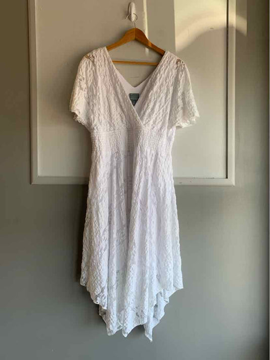 White lace dress with short sleeves and deep V-neck, handkerchief hem, size 14.