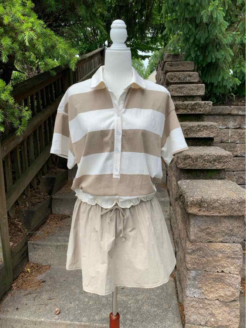 Tan and white striped short-sleeve collared shirt paired with tan drawstring shorts on a mannequin outdoors.