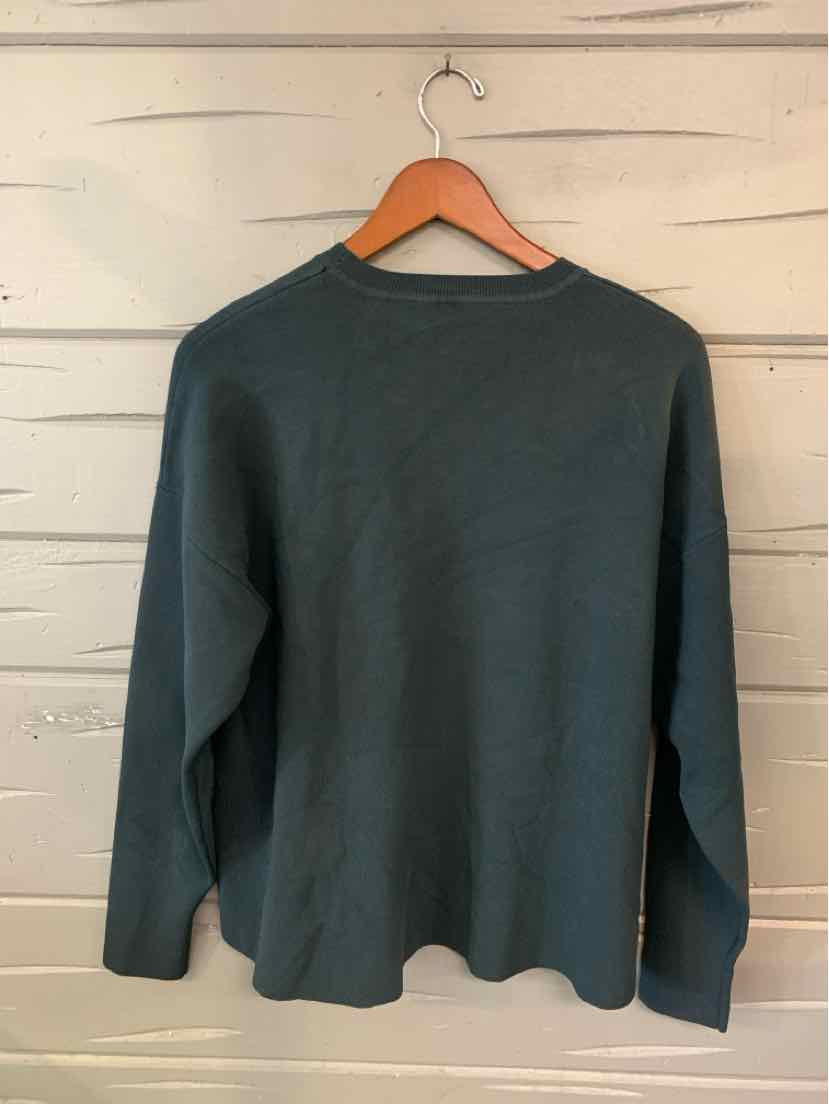 Dark gray long-sleeve crew neck sweater with a relaxed fit on a wooden hanger.