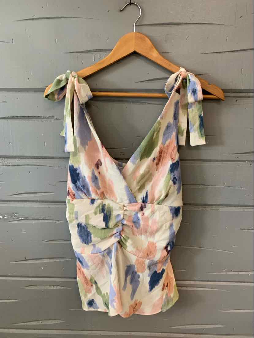 Floral print dress with pastel pink, green, and blue brushstroke pattern, tie straps, and ruched waist in medium size.