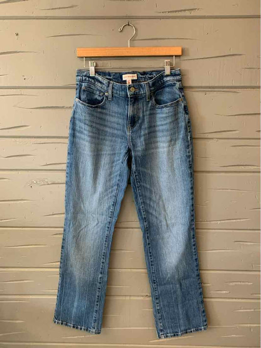 Blue denim Lucky Brand jeans in size 4 with classic five-pocket design and slight fading on thighs.