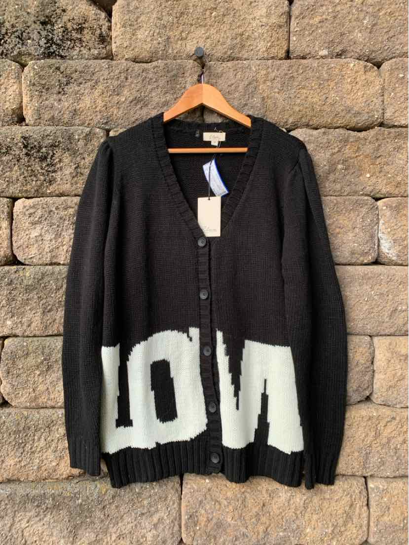 Black V-neck button-front cardigan with ribbed cuffs and hem, featuring bold white block lettering across the bottom.