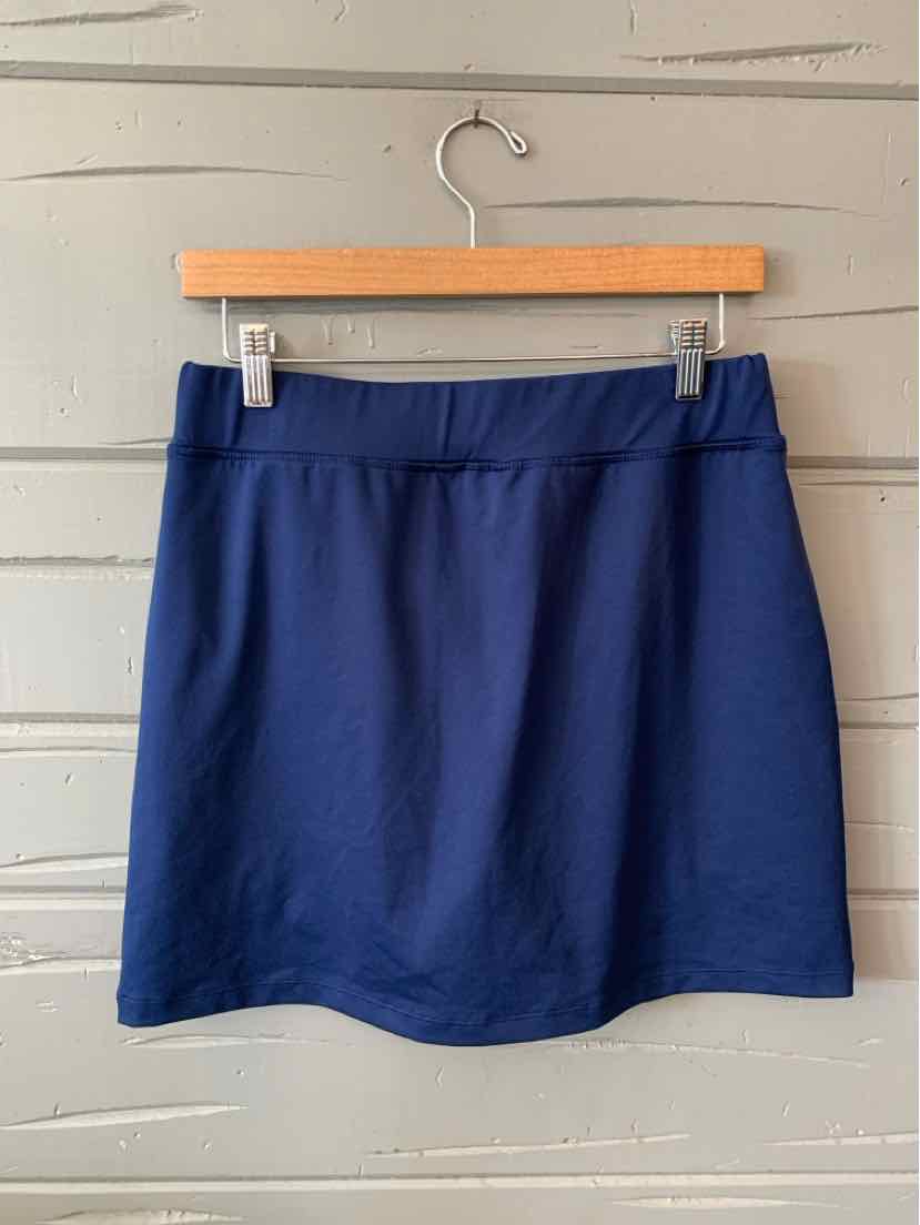 Navy blue medium skirt with a straight silhouette, elastic waistband, hanging on a wooden hanger.