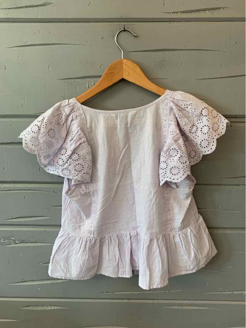 White eyelet lace blouse with flutter sleeves and peplum hem, lightweight cotton fabric.