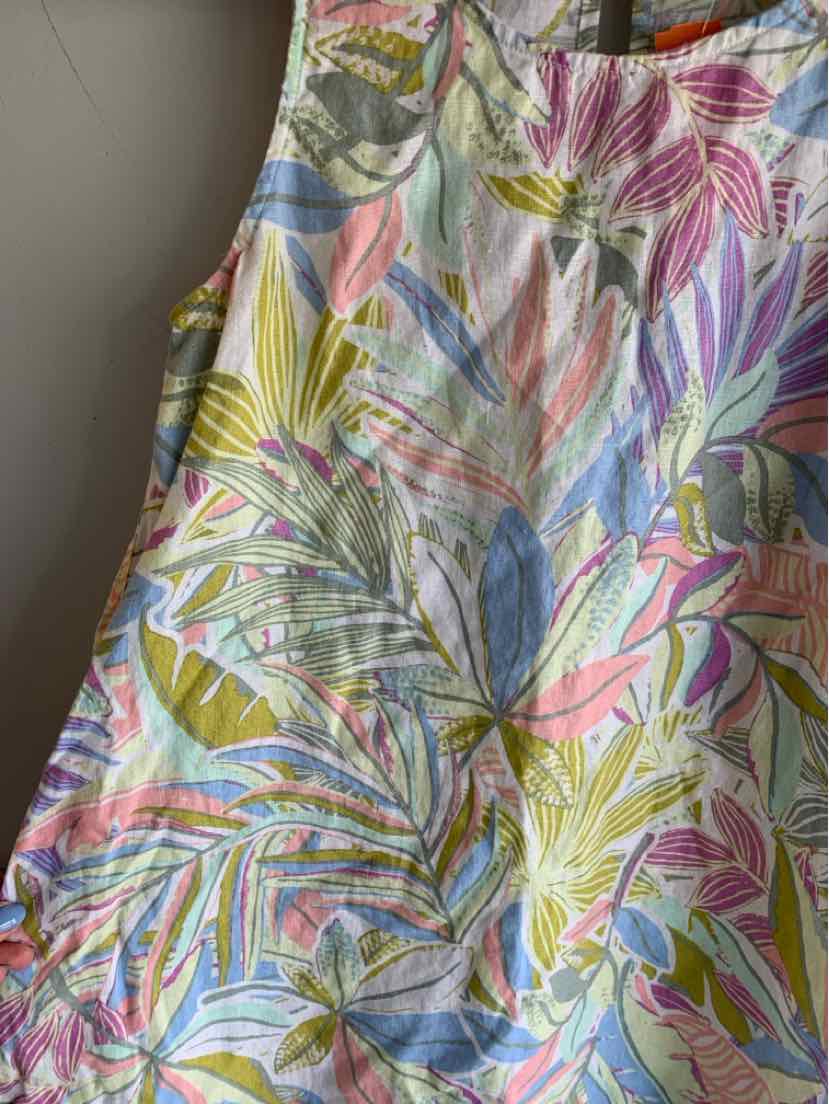 Sleeveless dress with colorful floral and leaf print in pink, green, blue, and yellow on light fabric.