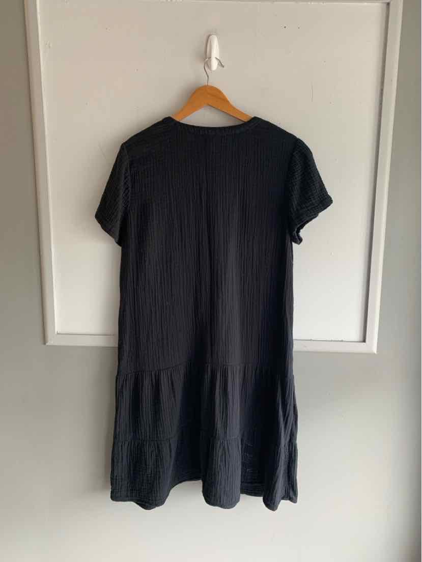 Black short-sleeve dress with a loose fit and tiered skirt detail in medium size.