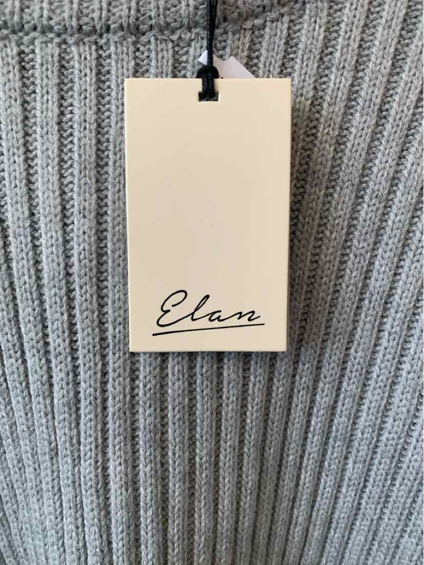 Gray ribbed knit fabric with a cream paper tag labeled Elan attached by black string.