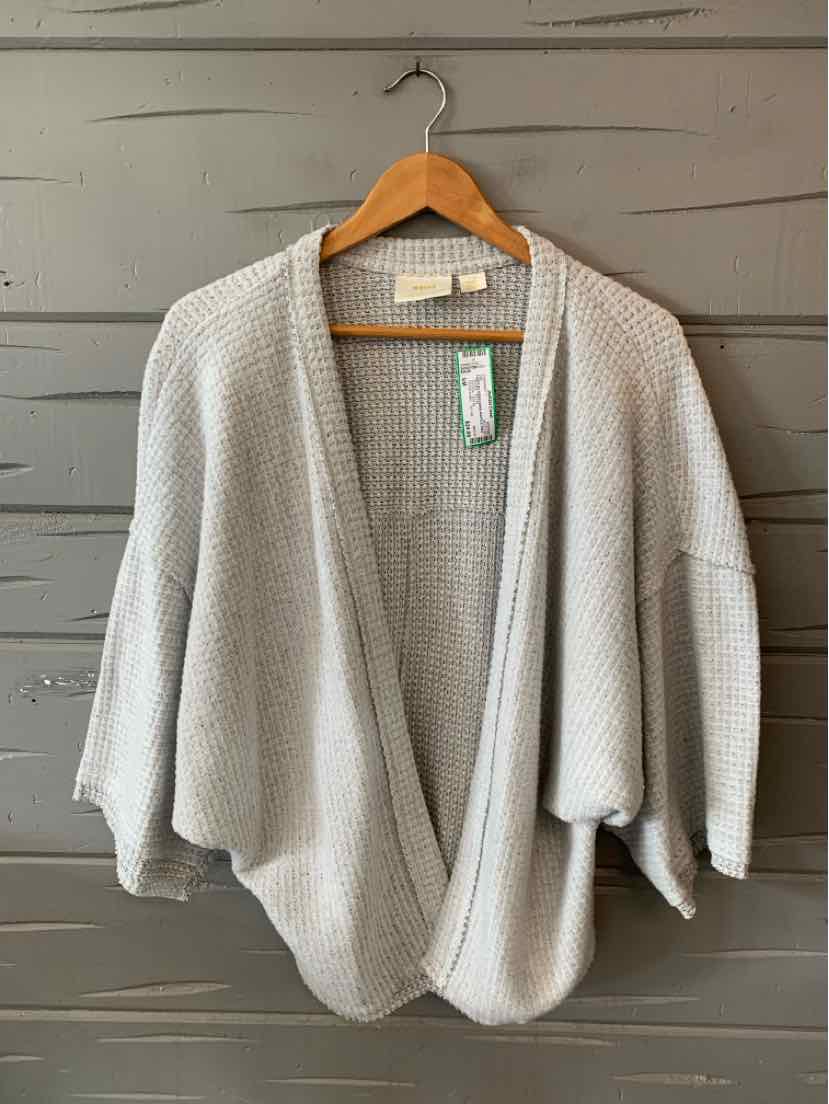 Light gray knit cardigan with a relaxed fit and wide three-quarter sleeves hanging on a wooden hanger.