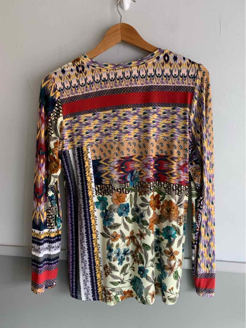 Long-sleeve blouse with multi-patterned floral and geometric prints in red, blue, beige, and green on lightweight fabric.
