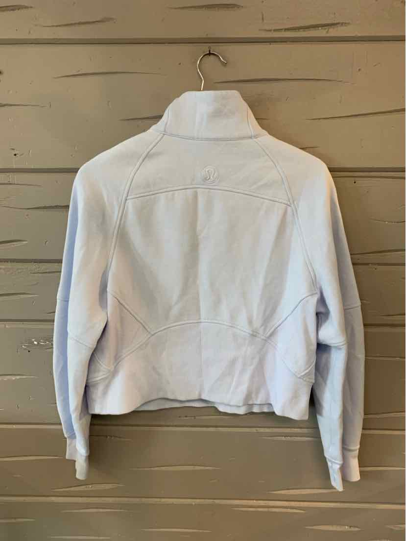 Light gray cropped jacket with long sleeves and high collar, structured seams, and soft fabric.