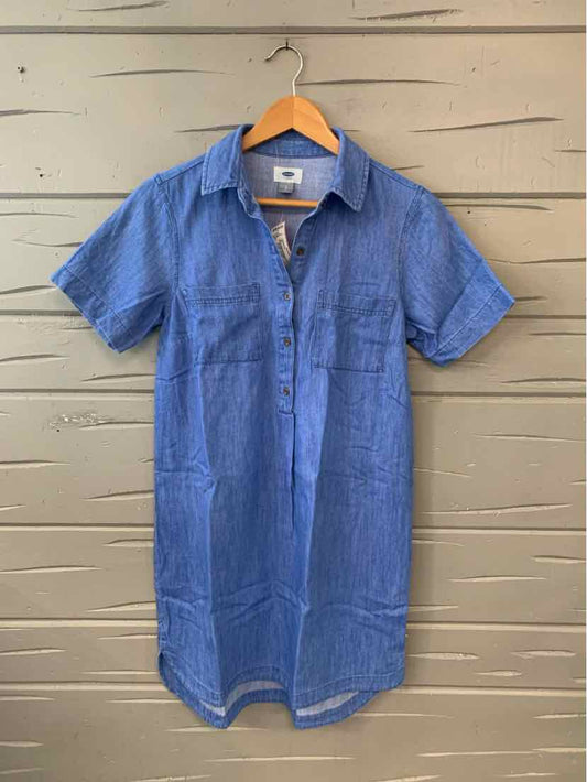 Blue short-sleeve casual dress with collar and front pockets hanging on wooden hanger.