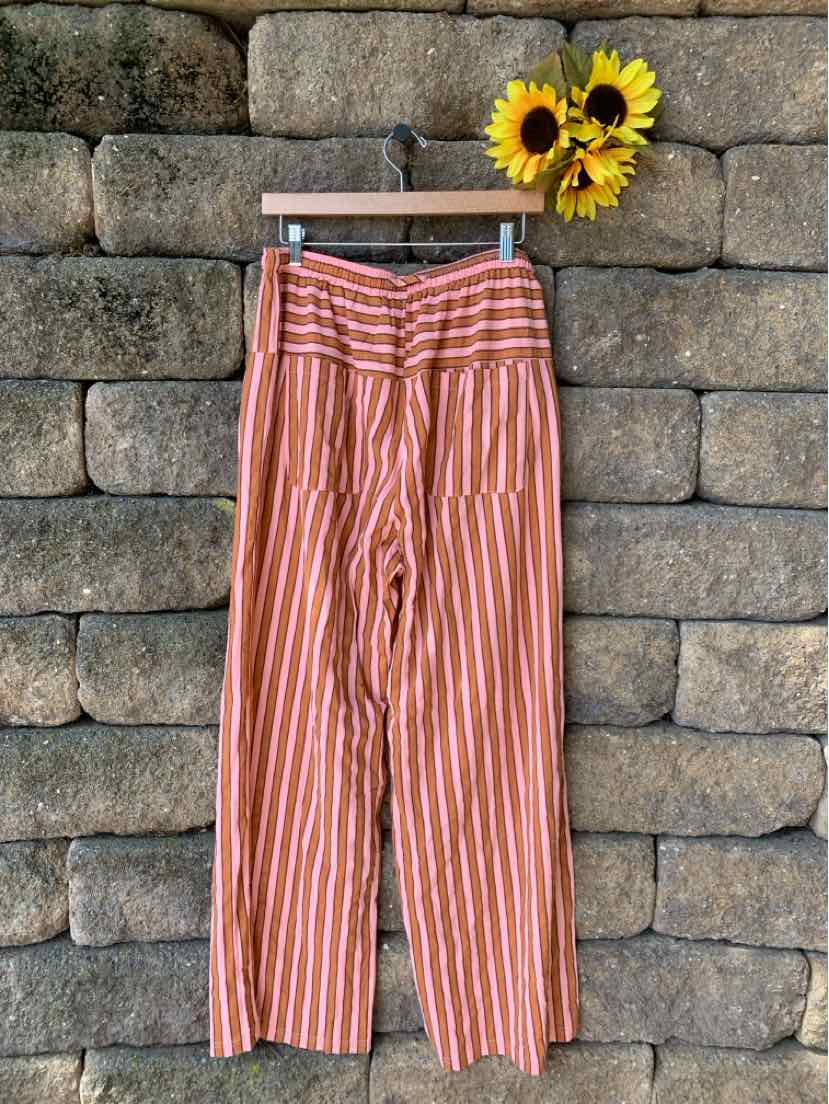 High-waisted wide-leg pants with vertical pink and white stripes made from lightweight fabric.